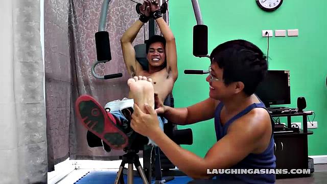 If you love male feet tickling, then this one is sure to excite you beyond your wildest dreams! Cute and sexy Asian boy Argie drops by for his first gym workout with Trainer.
