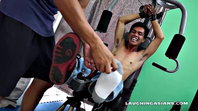 If you love male feet tickling, then this one is sure to excite you beyond your wildest dreams! Cute and sexy Asian boy Argie drops by for his first gym workout with Trainer.