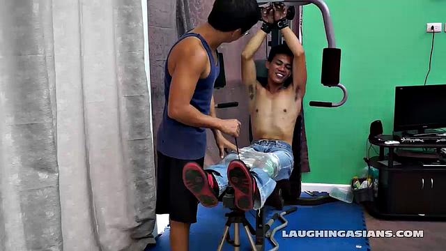If you love male feet tickling, then this one is sure to excite you beyond your wildest dreams! Cute and sexy Asian boy Argie drops by for his first gym workout with Trainer.
