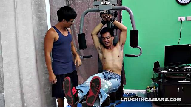 If you love male feet tickling, then this one is sure to excite you beyond your wildest dreams! Cute and sexy Asian boy Argie drops by for his first gym workout with Trainer.