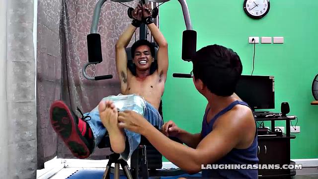 If you love male feet tickling, then this one is sure to excite you beyond your wildest dreams! Cute and sexy Asian boy Argie drops by for his first gym workout with Trainer.