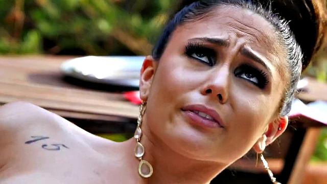 Latina with tattoos gets her trimmed pussy drilled from behind while giving a handjob in high heels