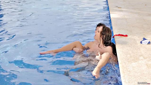 A trimmed-up cutie get her pussy licked & fucked in the pool by a lucky guy