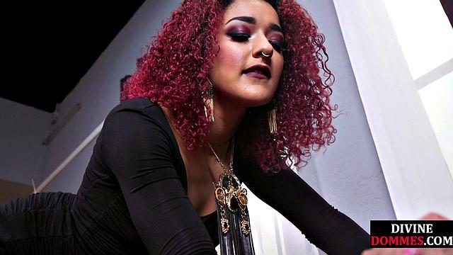 CBT submissive facing redhead dominatrix