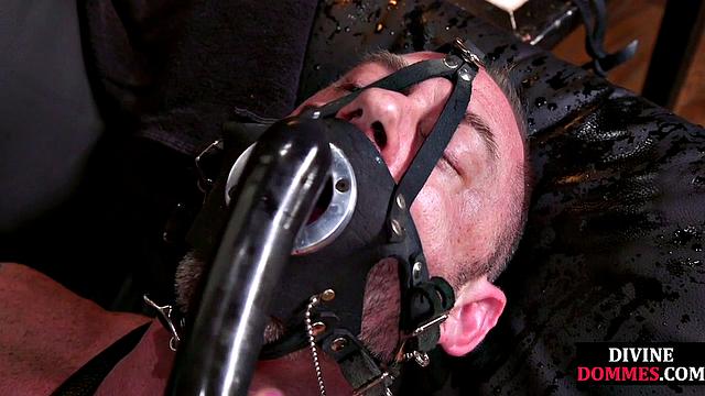 CBT submissive facing redhead dominatrix