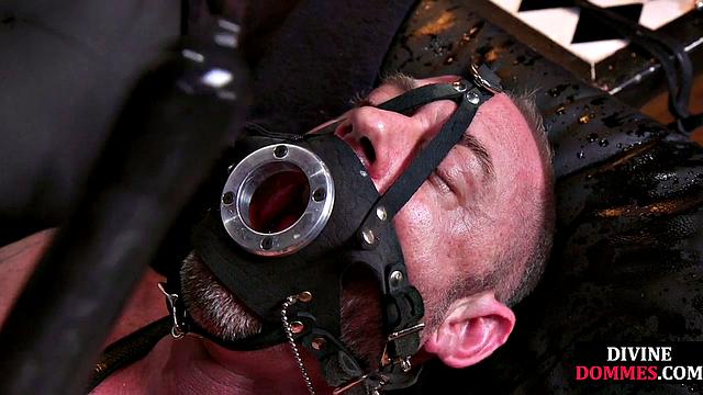 CBT submissive facing redhead dominatrix