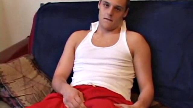 Gunner Raines rubs his cock thru his shorts, and then releases a growing boner. A sex toy plugs up Gunner's butthole. The added anal stimulation has the young man pumping a warm load onto his stomach.