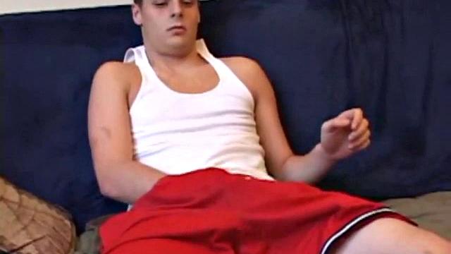 Gunner Raines rubs his cock thru his shorts, and then releases a growing boner. A sex toy plugs up Gunner's butthole. The added anal stimulation has the young man pumping a warm load onto his stomach.