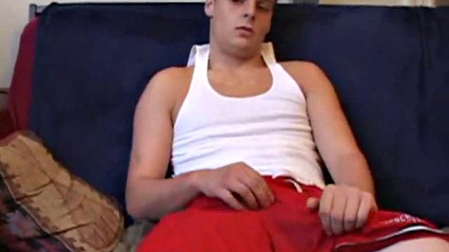 Gunner Raines rubs his cock thru his shorts, and then releases a growing boner. A sex toy plugs up Gunner's butthole. The added anal stimulation has the young man pumping a warm load onto his stomach.