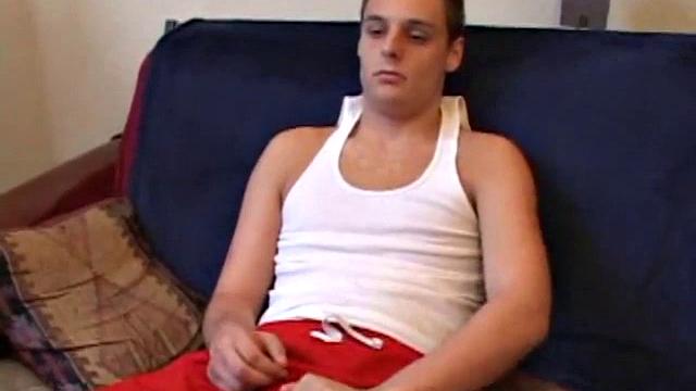 Gunner Raines rubs his cock thru his shorts, and then releases a growing boner. A sex toy plugs up Gunner's butthole. The added anal stimulation has the young man pumping a warm load onto his stomach.