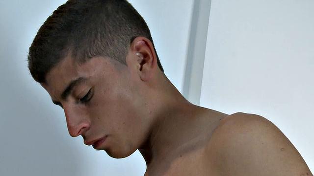 Our featured solo boy of the week is Adrian, who sits on a sofa and starts looking at porn on his phone. With the shirt off and pants unzipped, he takes hold of his growing uncut cock.