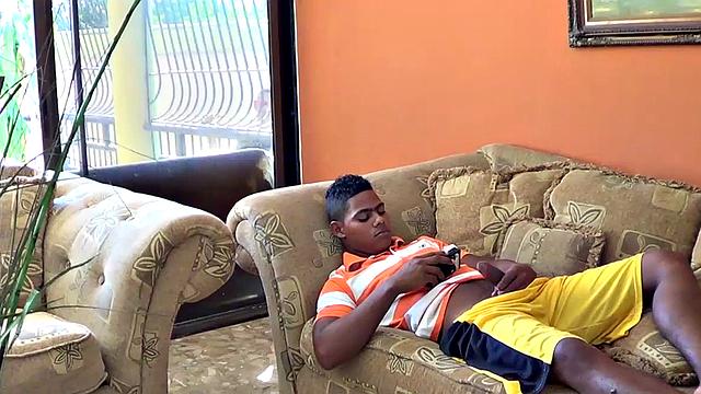 Santiago is on the sofa playing with his big uncut cock when Ramon spots him and joins in. He offers to help his friend out and goes down on Santiago, who clearly enjoys the attention.