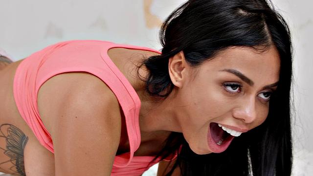 Brunette with tattoos rides cock in doggystyle with ass up and pussy down while getting a handjob and blowjob from a Colombian guy