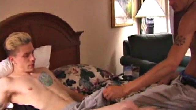 Derrick Hanson throws a porn magazine to Shane and keeps a magazine for himself. Lying on the hotel bed together they flip through the pictures of the magazines showing each other what pictures are turning them on.