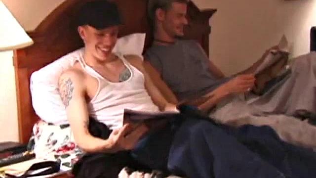 Derrick Hanson throws a porn magazine to Shane and keeps a magazine for himself. Lying on the hotel bed together they flip through the pictures of the magazines showing each other what pictures are turning them on.