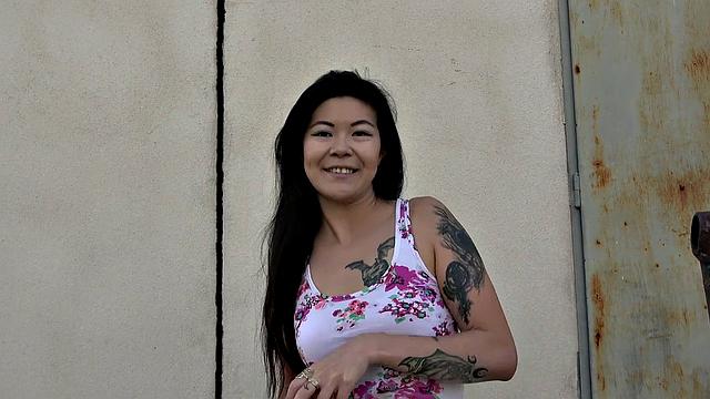 A tattooed Asian babe moan with pleasure as she gets girthy and takes it from behind