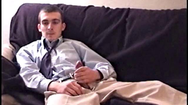Darrell kicks back on the couch and releases a big cock through his fly. At the same time, he pulls off his dress shirt and tie.