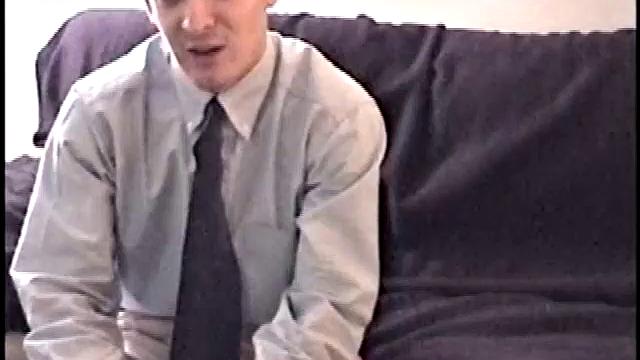 Darrell kicks back on the couch and releases a big cock through his fly. At the same time, he pulls off his dress shirt and tie.