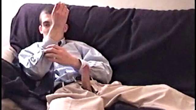 Darrell kicks back on the couch and releases a big cock through his fly. At the same time, he pulls off his dress shirt and tie.