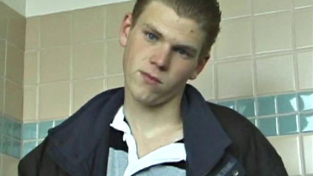 We catch up with Christian on an outdoor stairway. He leads us to a men's room with glory holes. Tere, Christian jacks off to photos in a straight porn magazine.