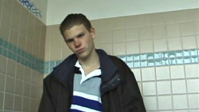 We catch up with Christian on an outdoor stairway. He leads us to a men's room with glory holes. Tere, Christian jacks off to photos in a straight porn magazine.