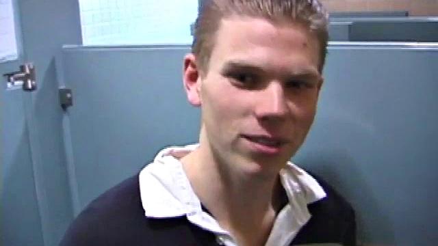 We catch up with Christian on an outdoor stairway. He leads us to a men's room with glory holes. Tere, Christian jacks off to photos in a straight porn magazine.