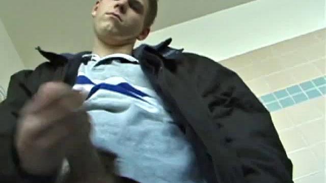 We catch up with Christian on an outdoor stairway. He leads us to a men's room with glory holes. Tere, Christian jacks off to photos in a straight porn magazine.