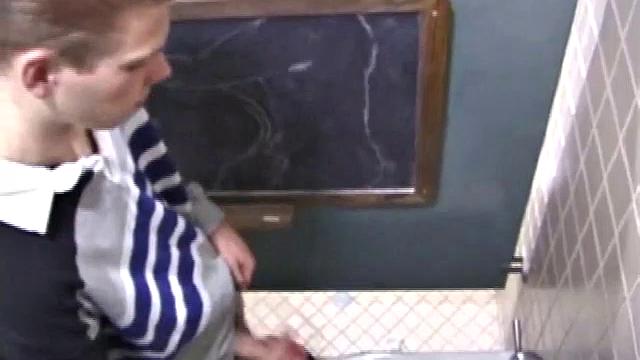 We catch up with Christian on an outdoor stairway. He leads us to a men's room with glory holes. Tere, Christian jacks off to photos in a straight porn magazine.