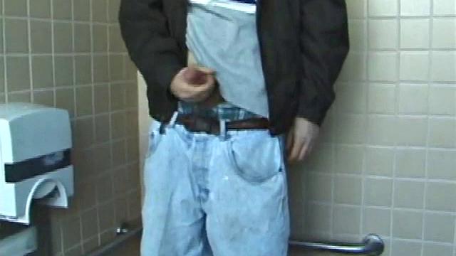 We catch up with Christian on an outdoor stairway. He leads us to a men's room with glory holes. Tere, Christian jacks off to photos in a straight porn magazine.