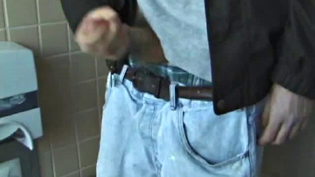 We catch up with Christian on an outdoor stairway. He leads us to a men's room with glory holes. Tere, Christian jacks off to photos in a straight porn magazine.