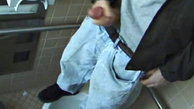 We catch up with Christian on an outdoor stairway. He leads us to a men's room with glory holes. Tere, Christian jacks off to photos in a straight porn magazine.