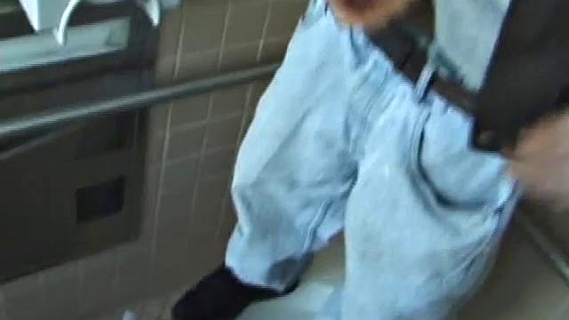 We catch up with Christian on an outdoor stairway. He leads us to a men's room with glory holes. Tere, Christian jacks off to photos in a straight porn magazine.