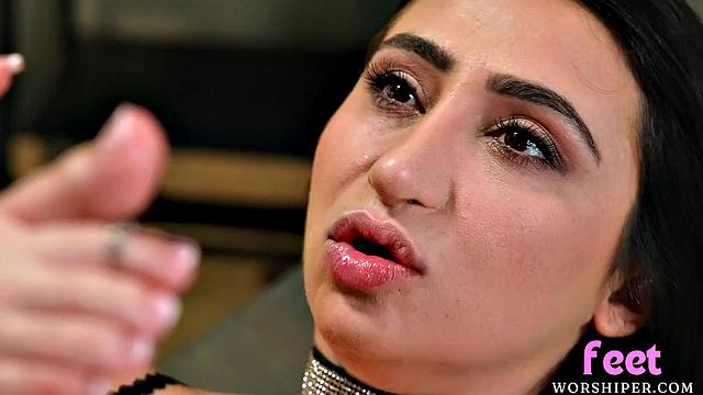 Busty babe gives lover a footjob