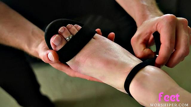 Busty babe gives lover a footjob