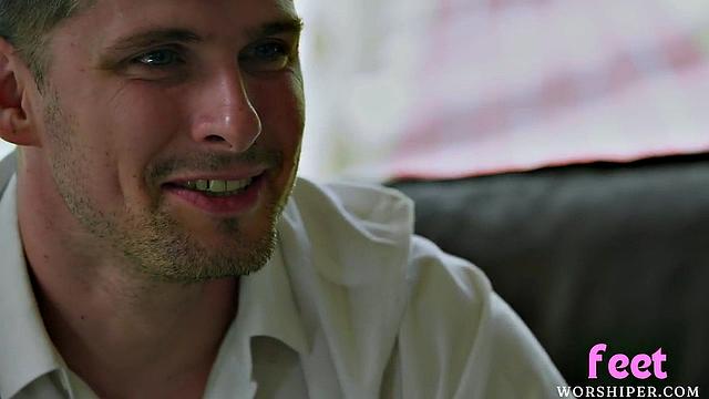 Busty babe gives lover a footjob