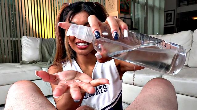 Dirty talking Asian cheerleader gives a titjob and footjob in hot POV action
