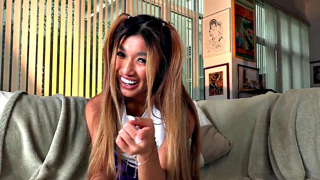 Dirty talking Asian cheerleader gives a titjob and footjob in hot POV action