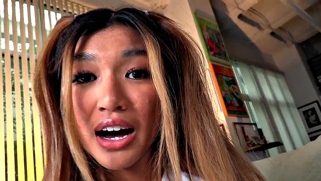 Dirty talking Asian cheerleader gives a titjob and footjob in hot POV action