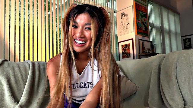 Dirty talking Asian cheerleader gives a titjob and footjob in hot POV action