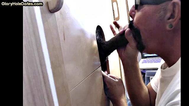 Horny DILF sucking BBC in gloryhole
