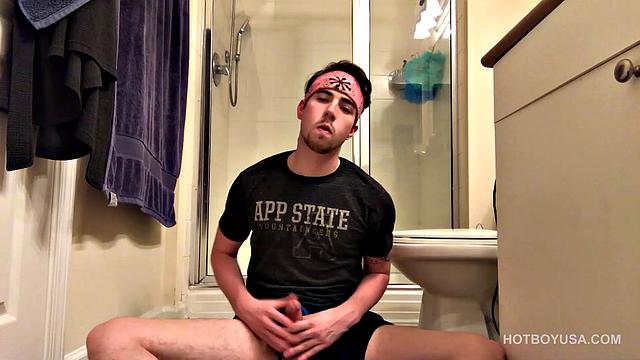 Cole Summers is on the bathroom floor, working up a boner, when we look in on him. He pulls that big stiff dick out the leg of his shorts and lets it pop out the waist band, as he edges himself.