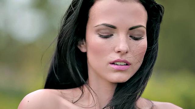 Watch this horny brunette with a trimmed pussy finger her way outdoors in a topless park thong and tank top