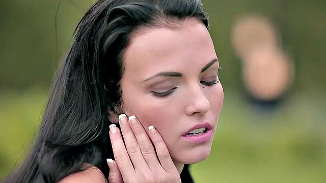 Watch this horny brunette with a trimmed pussy finger her way outdoors in a topless park thong and tank top