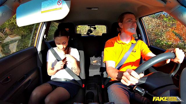 Tattooed brunette fucks for license