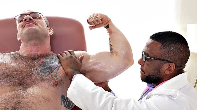 Muscled oiled hunk jerked off by doctor in infirmary