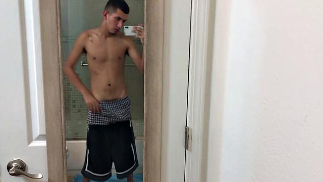 Slim and smooth Roman is in the bathroom, wearing only a pair of shorts. The young Latino gropes at his package until he's boned up. Then the shorts are pushed down to reveal his big uncut dick.