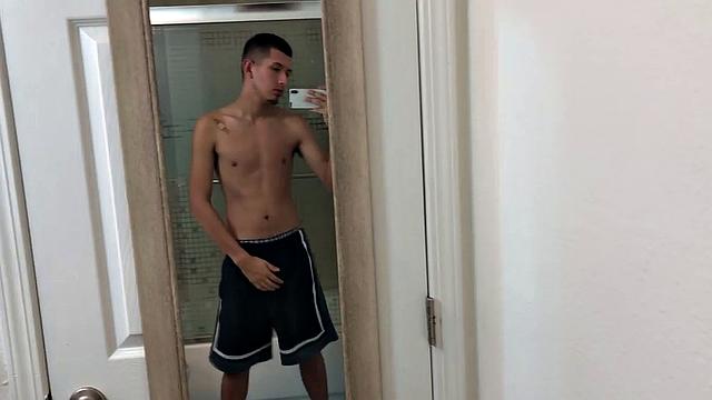 Slim and smooth Roman is in the bathroom, wearing only a pair of shorts. The young Latino gropes at his package until he's boned up. Then the shorts are pushed down to reveal his big uncut dick.