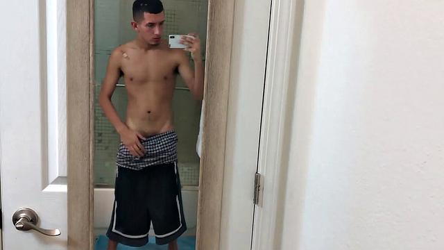 Slim and smooth Roman is in the bathroom, wearing only a pair of shorts. The young Latino gropes at his package until he's boned up. Then the shorts are pushed down to reveal his big uncut dick.