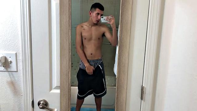 Slim and smooth Roman is in the bathroom, wearing only a pair of shorts. The young Latino gropes at his package until he's boned up. Then the shorts are pushed down to reveal his big uncut dick.