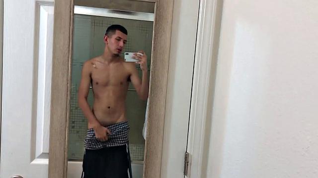 Slim and smooth Roman is in the bathroom, wearing only a pair of shorts. The young Latino gropes at his package until he's boned up. Then the shorts are pushed down to reveal his big uncut dick.